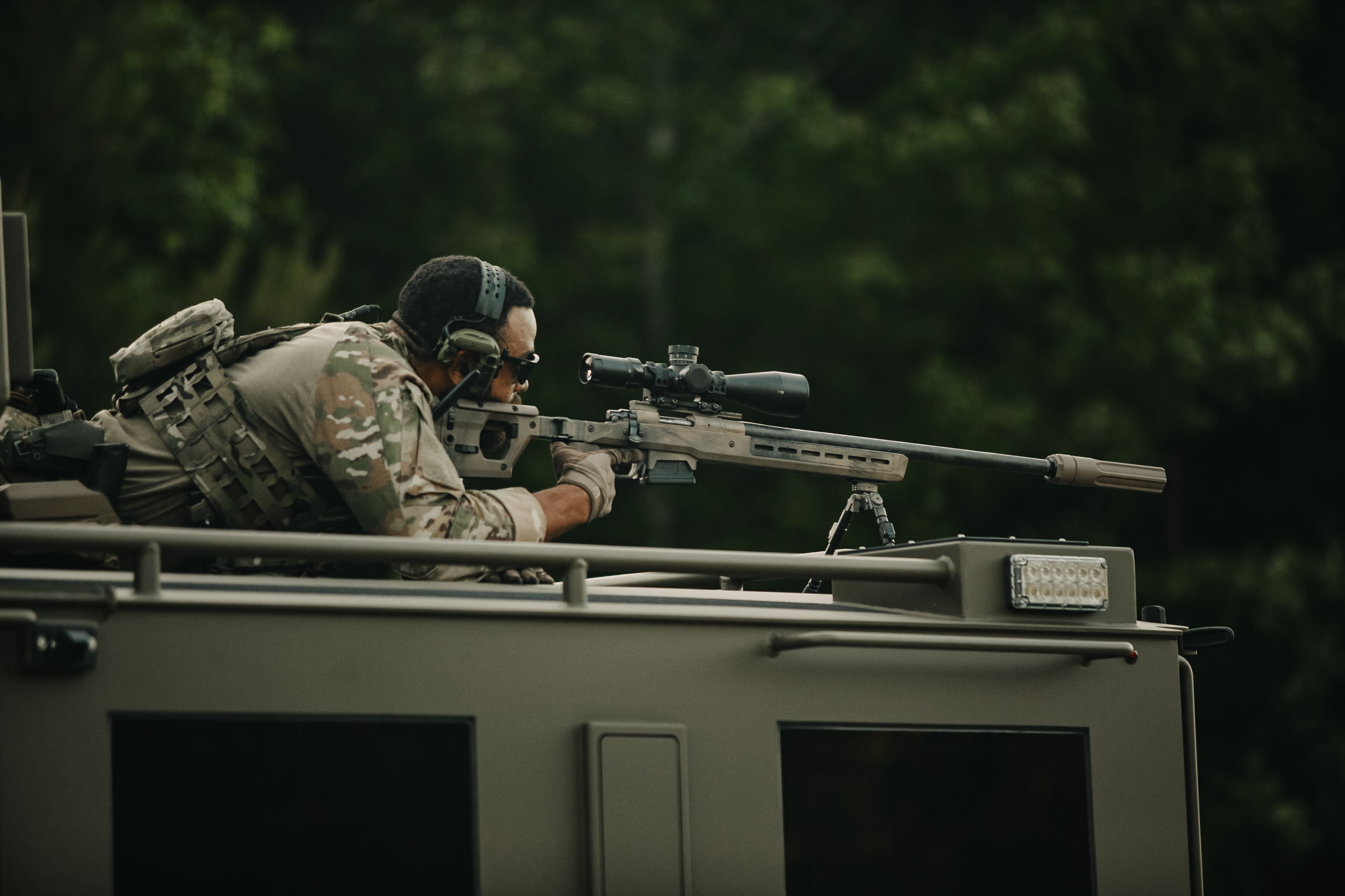 Suppressor mounted on a rifle, side profile