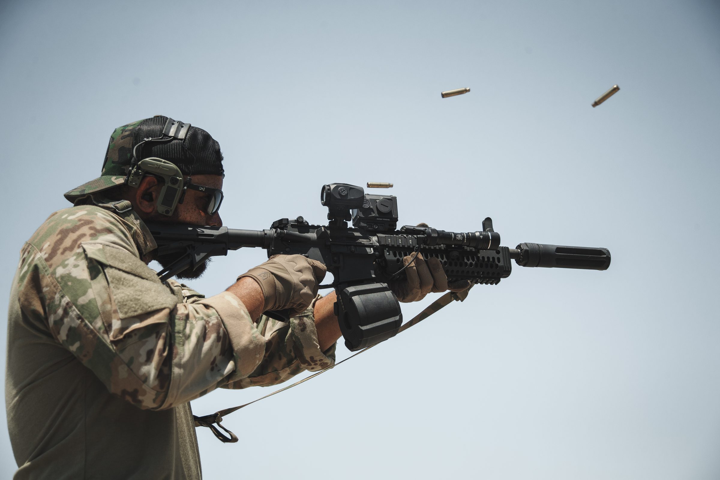 Operator firing suppressed 5.56 with brass in the air